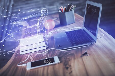 Desktop computer background in office and start up theme hologram drawing. Double exposure. Startup concept.の写真素材