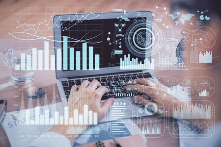 Multi exposure of forex graph with man working on computer on background. Concept of market...