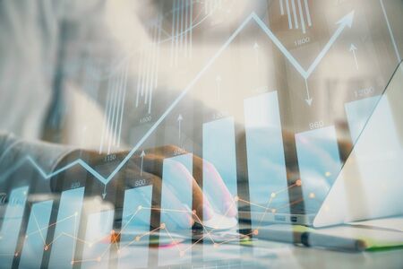 Double exposure of forex graph with man working on computer on background. Concept of market analysis.の写真素材