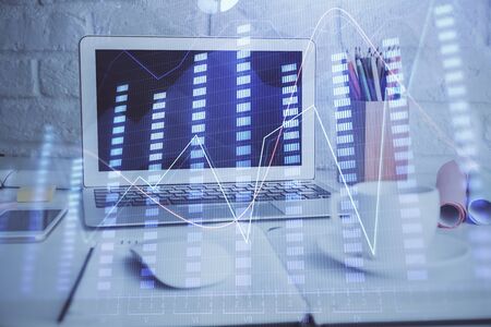 Stock market graph and table with computer background. Multi exposure. Concept of financial analysis.の写真素材