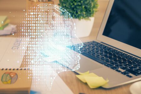 Double exposure of table with computer and brain hologram. Data innovation concept.