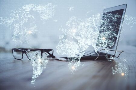 Computer on desktop with social network theme icon. Multi exposure. Concept of international connections.の写真素材