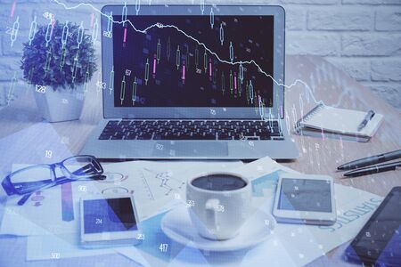 Financial chart drawing and table with computer on background. Multi exposure. Concept of international markets.の写真素材