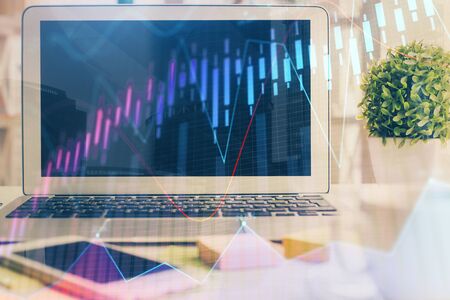 Stock market graph and table with computer background. Multi exposure. Concept of financial analysis.の写真素材