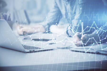 Multi exposure of forex chart with man working on computer on background. Concept of market...