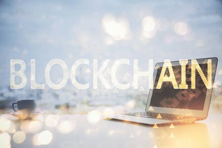Double exposure of blockchain theme hologram and table with computer background. Concept of bitcoin crypto currency.の写真素材