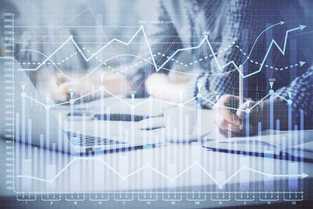 Multi exposure of forex chart with man working on computer on background. Concept of market...