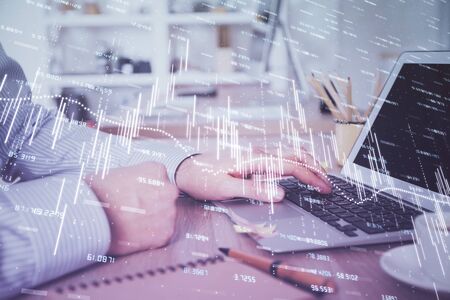 Multi exposure of stock market chart with man working on computer on background. Concept of financial analysis.の写真素材