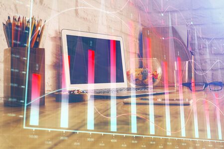 Double exposure of chart and financial info and work space with computer background. Concept of international online trading.の写真素材