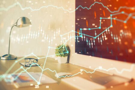 Forex market chart hologram and personal computer background. Multi exposure. Concept of investment.の写真素材