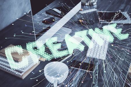 Desktop computer background in office and start up theme hologram drawing. Double exposure. Startup concept.の写真素材