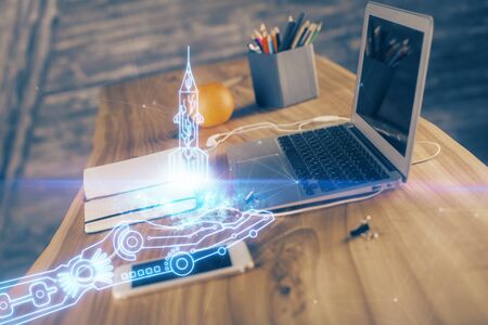 Desktop computer background in office and start up theme hologram drawing. Double exposure. Startup concept.の写真素材