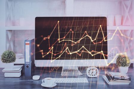 Forex graph hologram on table with computer background. Double exposure. Concept of financial markets.の写真素材