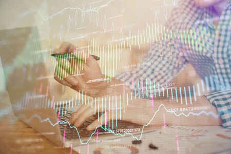 Multi exposure of forex graph with man working on computer on background. Concept of market analysis.の写真素材