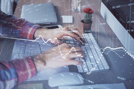 Double exposure of stock market chart with man working on computer on background. Concept of financial analysis.の写真素材