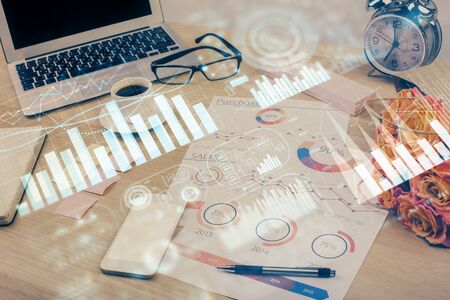 Financial market graph hologram and personal computer on background. Multi exposure. Concept of forex.の写真素材
