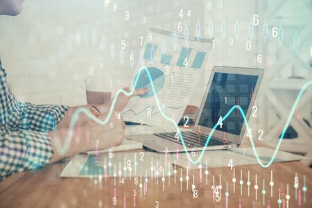 Double exposure of financial graph with man works in office on background. Concept of analysis.の写真素材