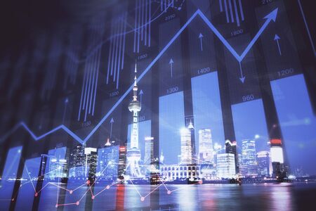 Financial graph on night city scape with tall buildings background multi exposure. Analysis concept.の写真素材