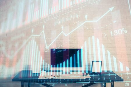 Forex market chart hologram and personal computer background. Multi exposure. Concept of investment.の写真素材