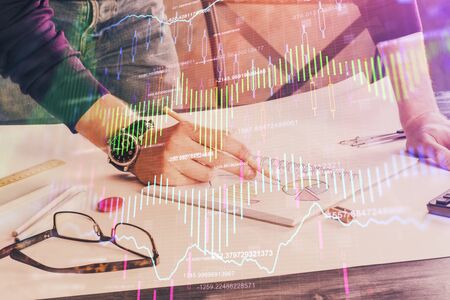 Financial trading chart doble exposure with man desktop background. Concept of success.の写真素材