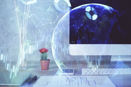 Stock market chart hologram drawn on personal computer background. Multi exposure. Concept of investment.の写真素材
