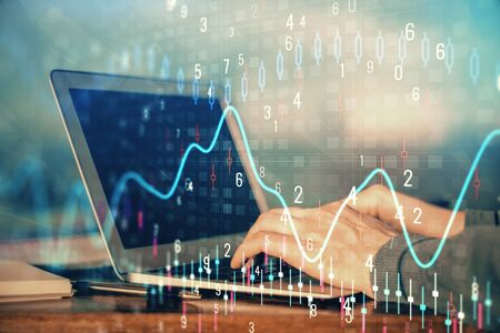 Double exposure of stock market graph with man working on laptop on background. Concept of financial analysis.の写真素材
