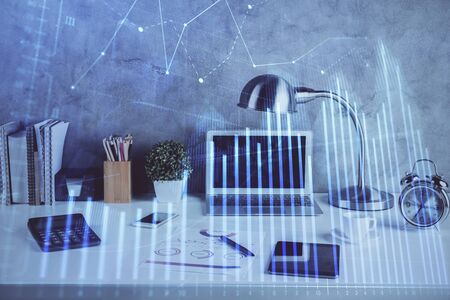 Double exposure of graph and financial info and work space with computer background. Concept of international online trading.の写真素材