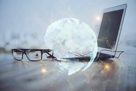 Computer on desktop with social network theme icon. Multi exposure. Concept of international connections.の写真素材