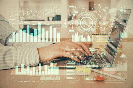 Double exposure of stock market graph with man working on laptop on background. Concept of financial analysis.の写真素材