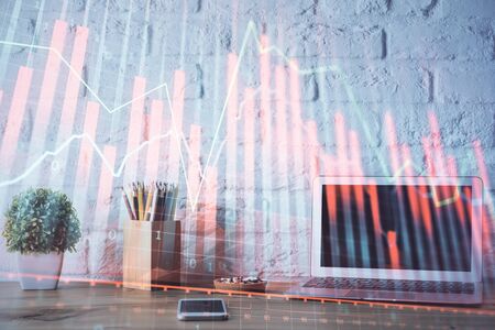 Financial chart drawing and table with computer on background. Double exposure. Concept of international markets.の写真素材