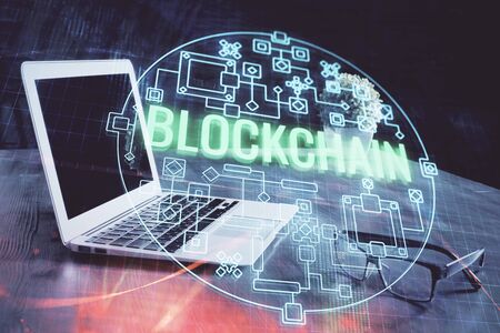 Double exposure of blockchain theme hologram and table with computer background. Concept of bitcoin...