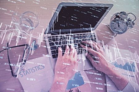 Multi exposure of forex graph with man working on computer on background. Concept of market analysis.の写真素材