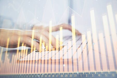 Forex graph with businessman working on computer in office on background. Concept of hardworking. Closeup. Multi exposure.の写真素材