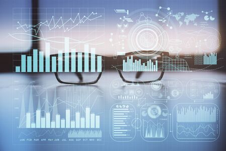 Financial graph hologram with glasses on the table background. Concept of business. Double exposure.
