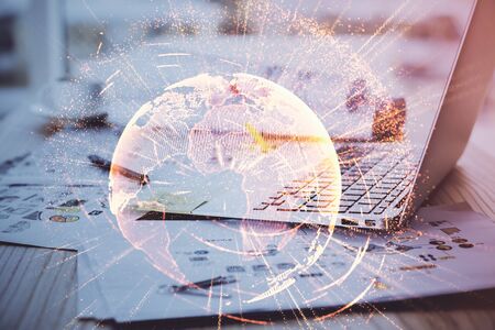 Computer on desktop with social network theme icon. Multi exposure. Concept of international connections.の写真素材