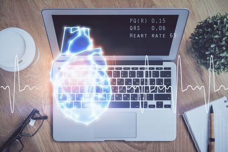 Desktop computer background and heart drawing. Double exposure. Medical study and healthcare concept.の写真素材