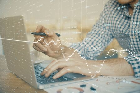 Multi exposure of forex graph with man working on computer on background. Concept of market analysis.の写真素材
