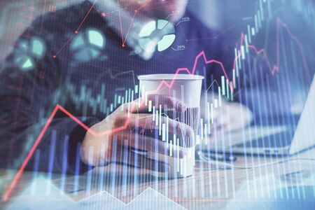 Forex graph with businessman working on computer in office on background. Concept of hardworking....