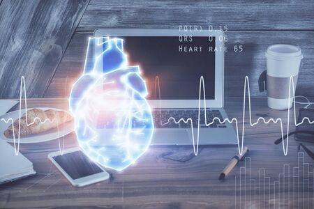 Desktop computer background and heart drawing. Double exposure. Medical study and healthcare concept.の写真素材