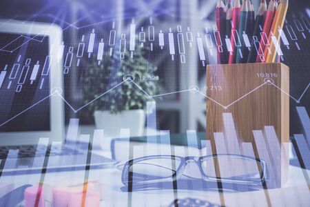 Financial chart hologram with glasses on the table background. Concept of business. Double exposure.の写真素材