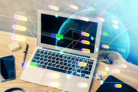 Multi exposure of table with computer and world map hologram. International data network concept.の写真素材