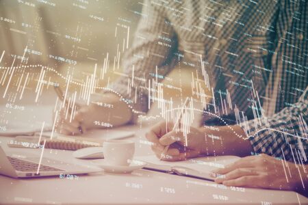 Multi exposure of forex chart with man working on computer on background. Concept of market...