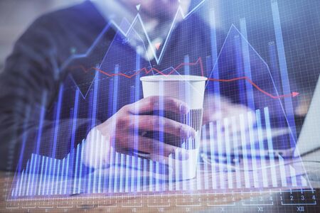 Forex graph with businessman working on computer in office on background. Concept of hardworking....