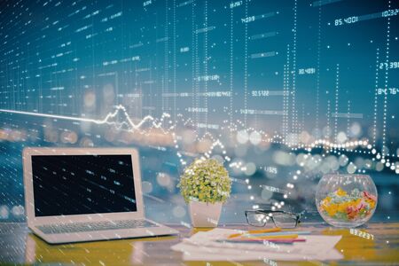 Forex graph hologram on table with computer background. Double exposure. Concept of financial...