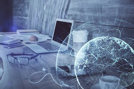 Computer on desktop with social network hologram. Multi exposure. Concept of international people...