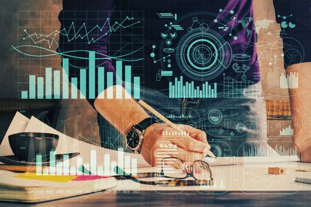 Double exposure of man writing on paper with forex graph. Concept of research and trading.