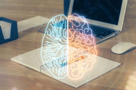 Multi exposure of work table with computer and brain hologram. Brainstorm concept.