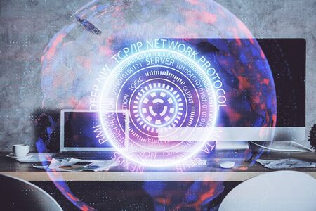 Computer on desktop in office with technology theme hologram. Multi exposure. Tech concept.の写真素材