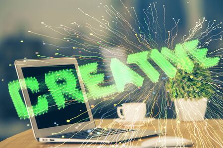 Desktop computer background in office and start up theme hologram drawing. Double exposure. Startup concept.の写真素材