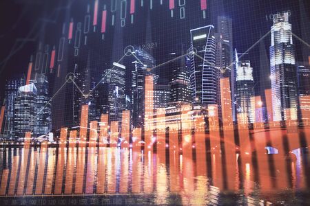 Financial chart on city scape with tall buildings background multi exposure. Analysis concept.の写真素材